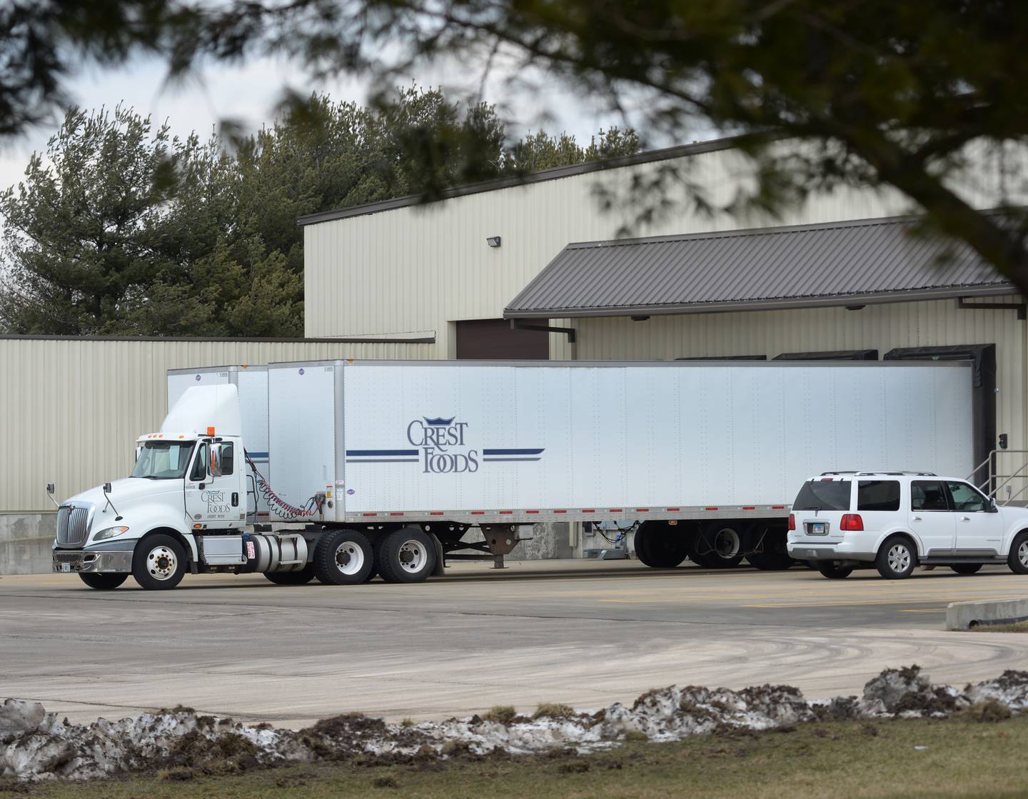 A semi-tractor and trailer sits at one of the loading bays at the warehouse portion of Crest Foods on Thursday, Feb. 8, 2024.