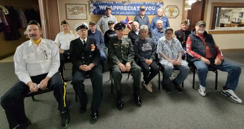 Veterans attending the Veterans Day luncheon at Plano Methodist Church on Nov. 11, 2025 are (front row seated) Michael Downey, Art Killey, Wendell Dominy, Lori Denman, Michael Kimmey, Bob Mauer; (seated in middle row) Ron Bauer, David Blackburn, Don Haag, Gerald Moutray, Henry Baumann Jr, Gary Fruland; (standing in back row) Michael Korallus, Tom Banning, Cliff Oleson.