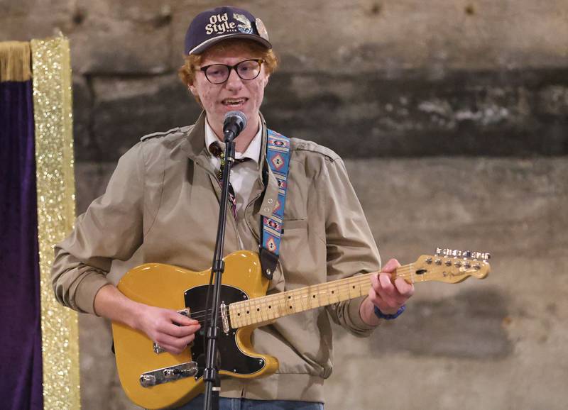 Jackson Delhotal, a senior at Putnam County High School, plays guitar during the 9th annual NCI Artworks Mad Hatter Ball on Friday, Jan. 16, 2026 at the Westclox Event Center in Peru. Delhotal, has played guitar for 10 years and is involved with AP arts and journalism.