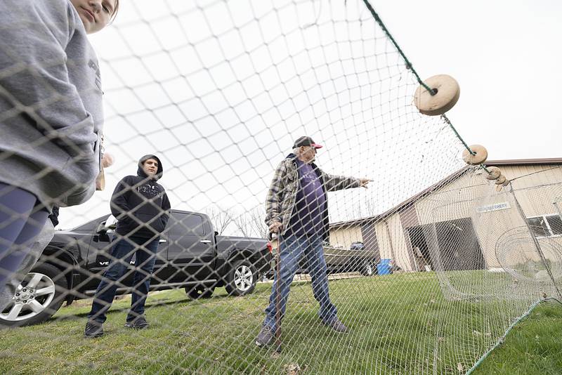 Lake Carroll Fish Hatchery volunteer Len Masella talks to a group of school kids from West Carroll Middle School about the process of netting grown walleye. The hatchery exclusively grows walleye for lake fishing.