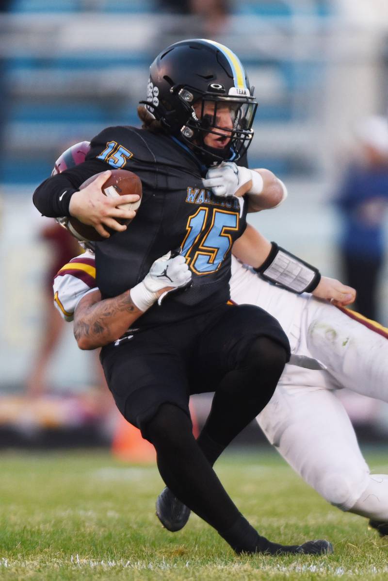 Joe Lewnard/jlewnard@dailyherald.com
Maine West quarterback Thomas Delaney gets sacked by Schaumburg’s Daniel Uczarczyk during Friday’s game in Des Plaines.