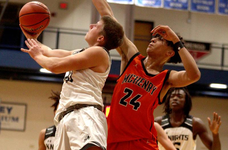 McHenry’s  Adam Anwar (24) defends as Kaneland’s Troyer Carlson moves the ball in Hoops for Healing basketball tournament championship game action at Woodstock Wednesday.