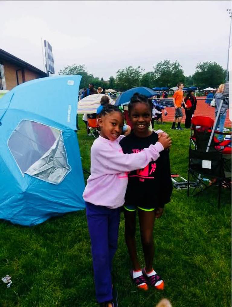 A young Sariyah Watson (left) and Raven Meeks, of DeKalb, pose outside a DeKalb track meet as children in this undated photo. The two girls went on to run together on the Barbs girls' track and field team. Watson, now 21, was killed in a wrong-way crash on Interstate 88 near Aurora on Sunday, May 10, 2026.