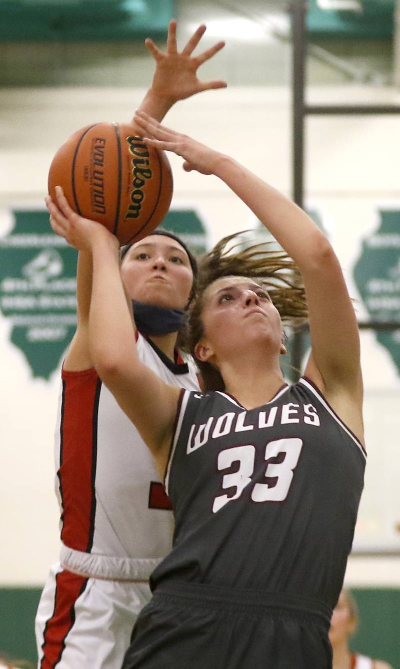 Prairie Ridge's Karsen Karlblom drives to the basket against Deerfield’s Aubrey Gavlan during a IHSA Class 3A Grayslake Central Sectional semifinal basketball game Tuesday evening, Feb. 22, 2022, between Prairie Ridge and Deerfield at Grayslake Central High School.