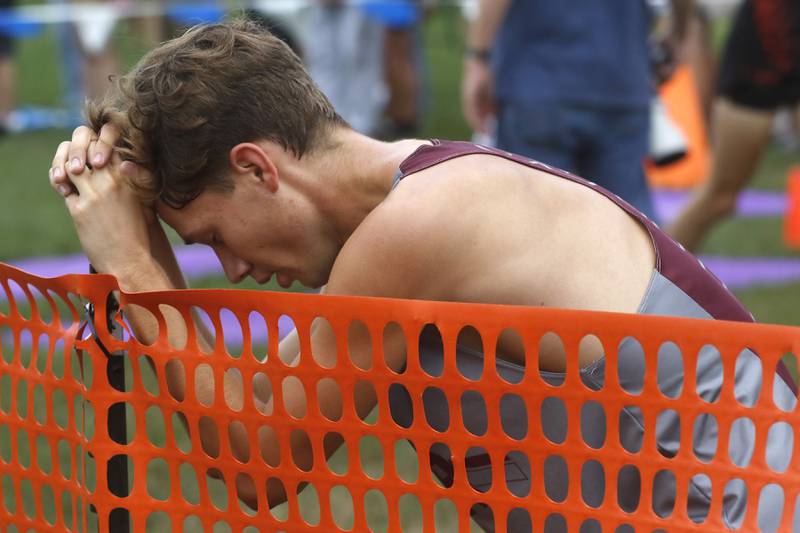 Prairie Ridge’s EddyKlimkowski catches his breath after finishing the boys race of the McHenry County Cross Country Meet Saturday, August 27, 2022, at Emricson Park in Woodstock.