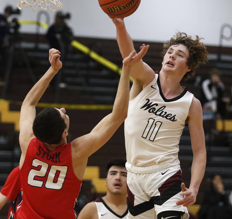 Prairie Ridge's James Muse hits the ball away from South Elgin’s Derek Clark during a Hinkle Holiday Classic basketball game Tuesday, Dec. 27, 2022, at Jacobs High School in Algonquin.