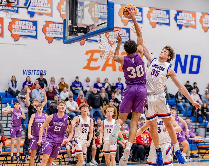 Pecatonica's Zion Braimah goes up for a dunk against Eastland's Parker Krogman on Thursday, Dec. 19, 2024 at Eastland High School.