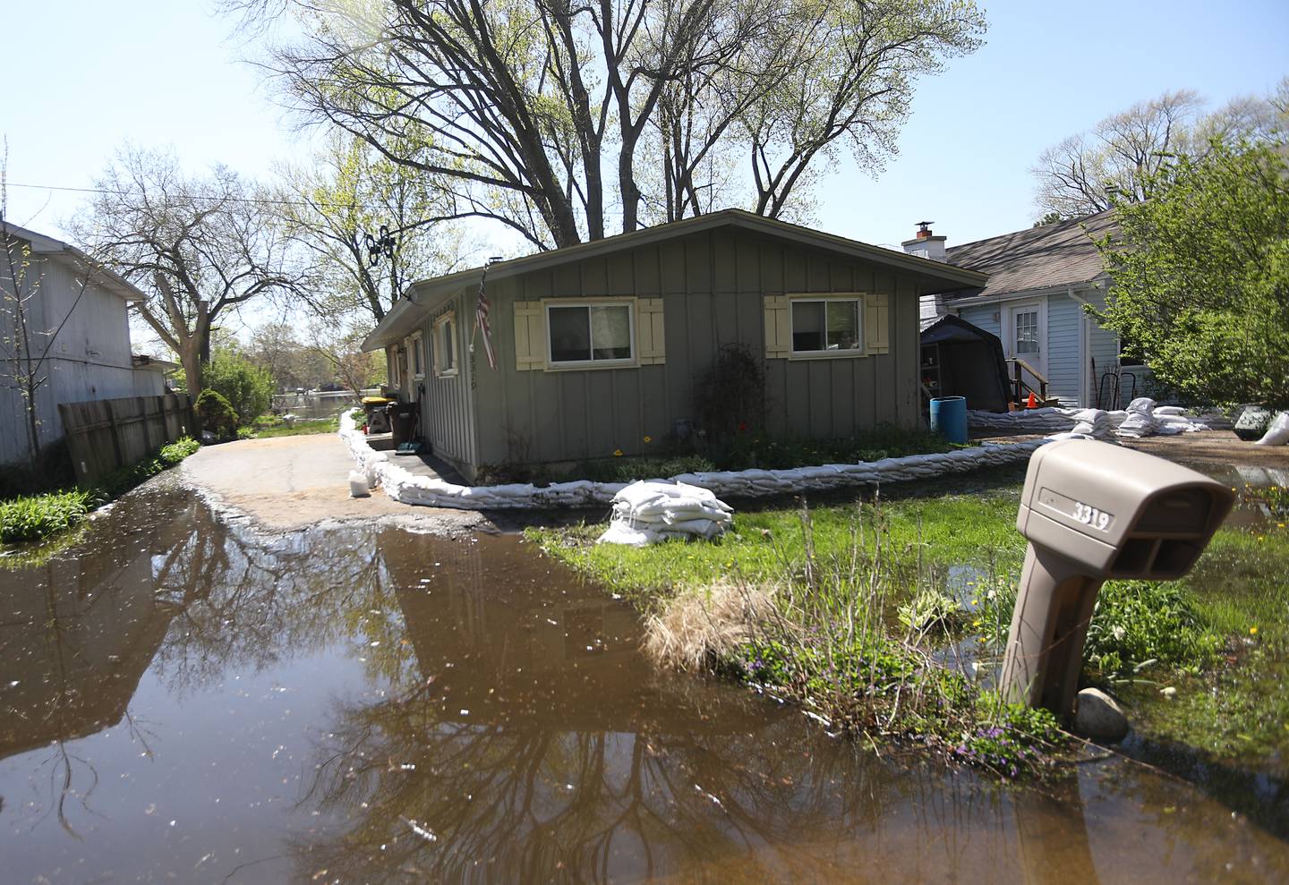 Sandbags protect a home near Burtons Bridge as flooding continues on the Fox River on Wednesday, April 22, 2026.