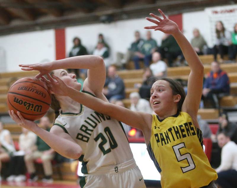 St. Bede's Lili McClain eyes the hoop as Putnam County's Eme Bouxsein defends during the Tri-County Conference Tournament championship game on Thursday, Jan. 18, 2024 at Henry-Senachwine High School.