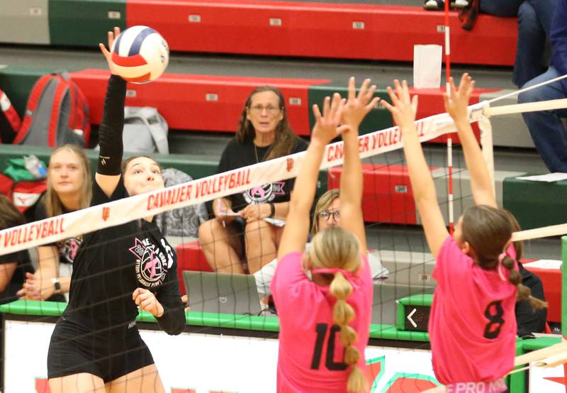 Ottawa's Mary Stisser sends a kill past L-P's Kelsey Frederick and teammate Jordan Whaley during Volley for a Cure night on Tuesday, Oct. 1, 2024 at AJ Sellett Gymnasium.
