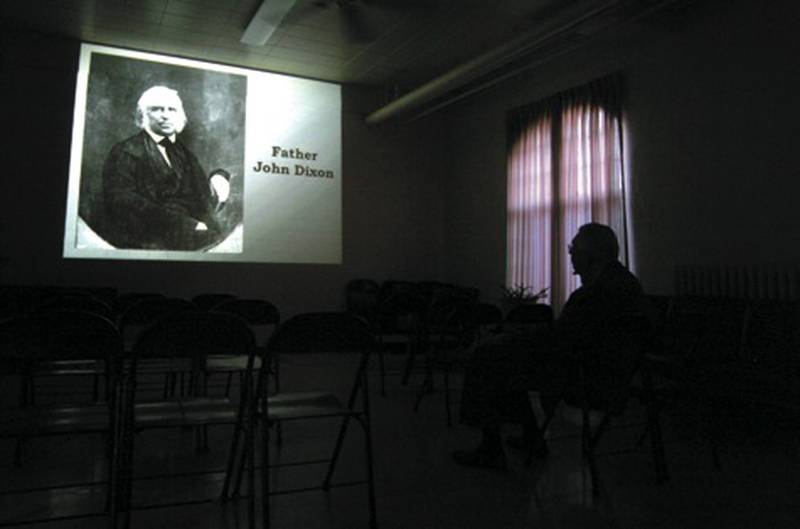 Pictures of historic Dixon and Lee County citizens are projected on a wall Friday during a presentation by the Lee County Genealogical Society at Dixon Main Street’s Founder’s Day celebration.