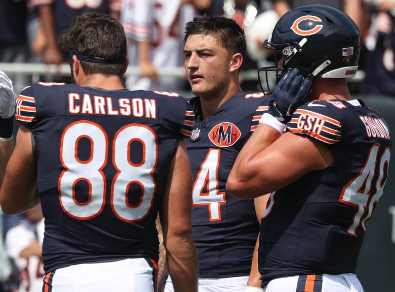 Chicago Bears tight end Colston Loveland (middle) talks to teammates Sunday, Aug. 10, 2025, before their preseason game against the Miami Dolphins at Soldier Field in Chicago.