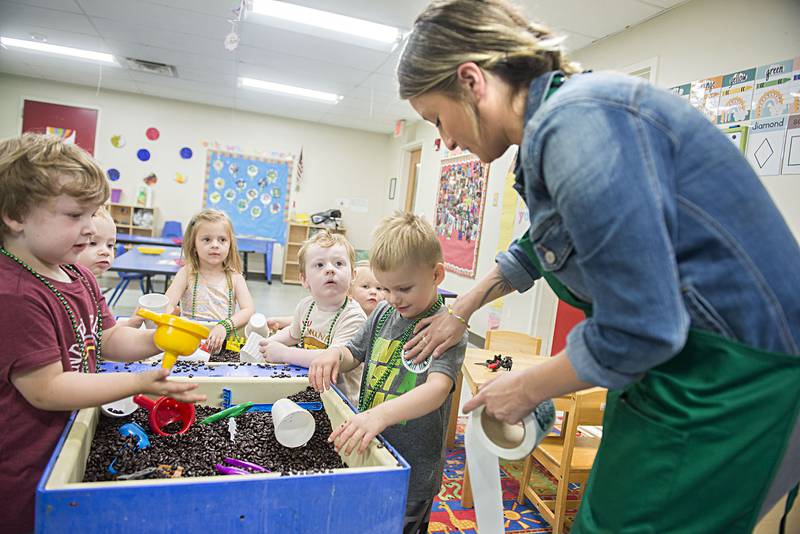 Mckenzie Newcomer, acting assistant manager at the Sterling Starbucks, hands out stickers to the kids at the YMCA daycare in Dixon on Tuesday, July 19, 2022. The coffee company paid a visit to the kids to help promote the opening of their new store in Dixon.