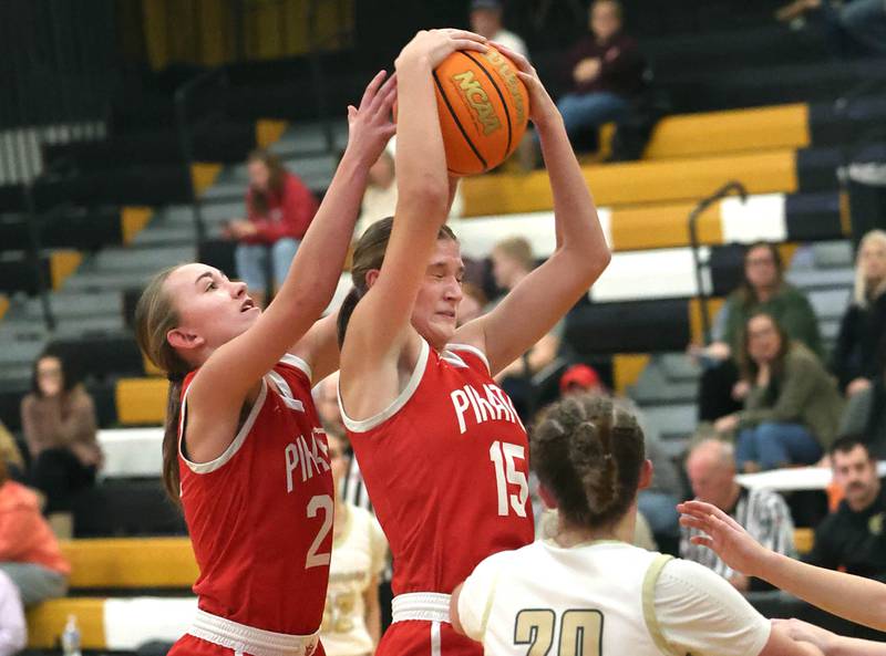 Ottawa's Addy Miller (left) and Hailey Larsen go after a rebound in front of Sycamore's Callie Countryman during their game Friday, Jan. 10, 2025, at Sycamore High School.