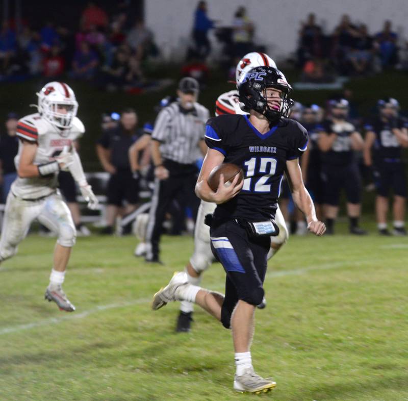 Eastland-Pearl City's Adam Awender (12) runs from Forreston defenders for a touchdown on Friday, Sept. 20, 2024 in a NUIC Conference game at Pearl City.