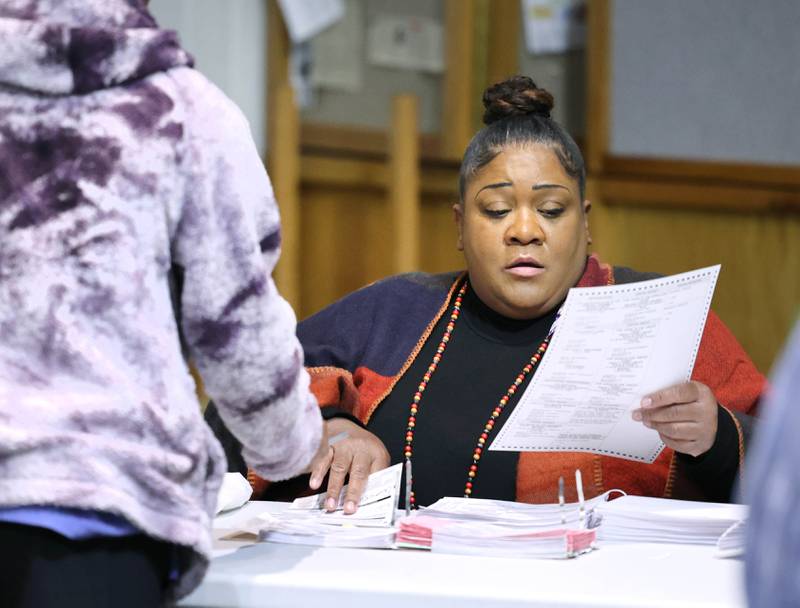 Election Judge Marian Richardson helps a voter get started on Election Day, Tuesday, Nov. 8, 2022, at the polling place in Westminster Presbyterian Church in DeKalb.