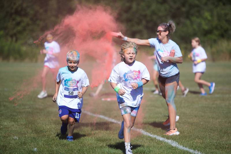 Kids run through the colors at the Glen Ellyn 2K Kids Color Bash Run on Saturday Aug.10, 2024 at Ackerman Park in Glen Ellyn.