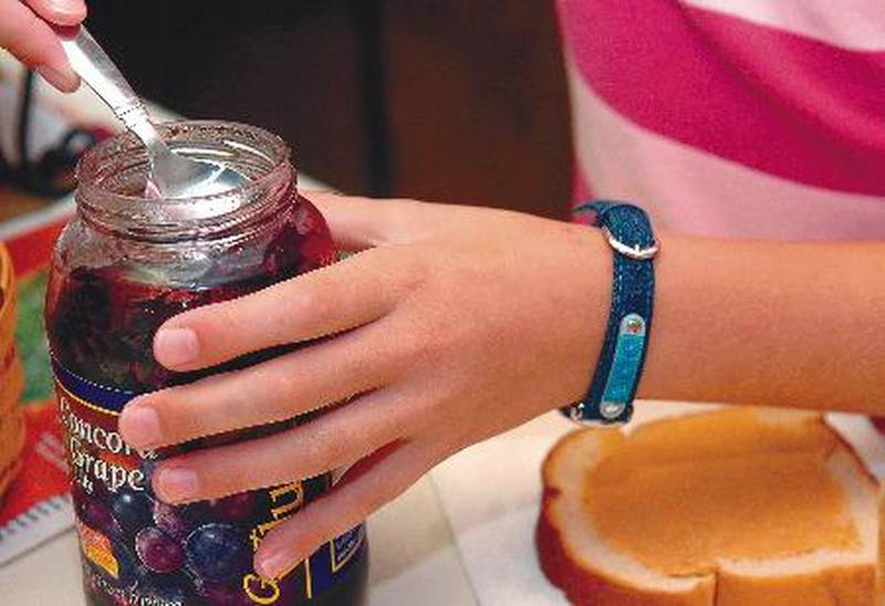Philip Marruffo Zoey Colglazier, a fourth grader at Jefferson School in Dixon, scopes out jelly for her peanut butter and jelly sandwich before school Friday morning. Zoey makes her cold lunch on the days when she does not like the hot lunch the school offers.