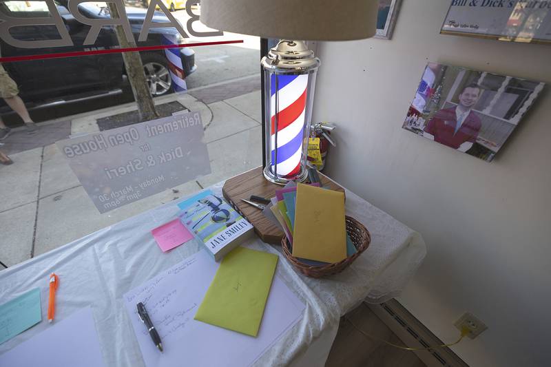A custom-made barber pole light was gifted to Dir along with books and cards celebrating his retirement.