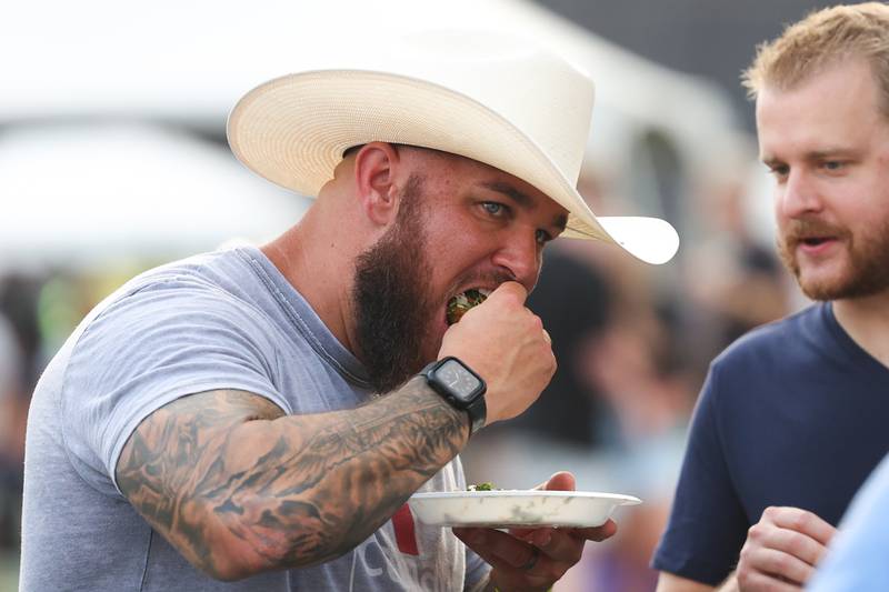 Mike Janovyak, Minooka, enjoys some Sunshine Mexican Cafe tacos on day 2 of the Taste of Joliet. Saturday, June 25, 2022 in Joliet.