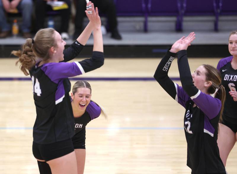 Dixon players celebrate a point against Ottawa Tuesday, Oct. 28, 2025, during their Class 3A regional semifinal match at Rochelle High School.