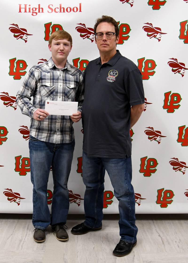 Chance Hank (left) received the Lambert Jones Auto Technology Scholarship, presented by Mike Fisher (right), Area Career Center automotive teacher. The $2,000 scholarship is awarded to seniors who plan to major in auto technology and who has at least a C average GPA.