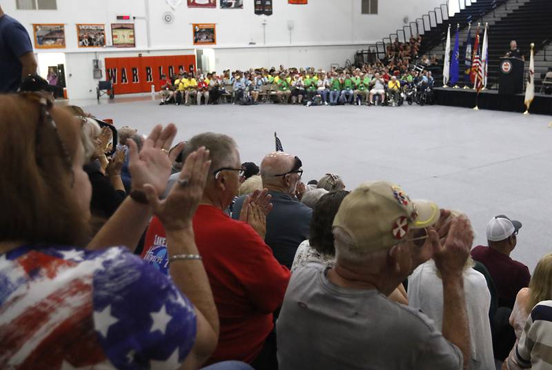 People clap for veterans during an Honor Flight trip homecoming celebration on Sunday, Aug. 27, 2023, at McHenry Community High School.