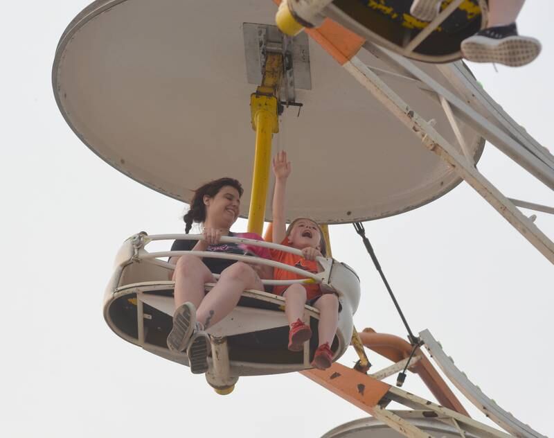 Katy Beckingham of Dixon (left) smiles as Matix Sippel, 5, also of Dixon, enjoys the Paratrooper carnival attraction at Town & Country Days in Polo on Thursday, June 15.