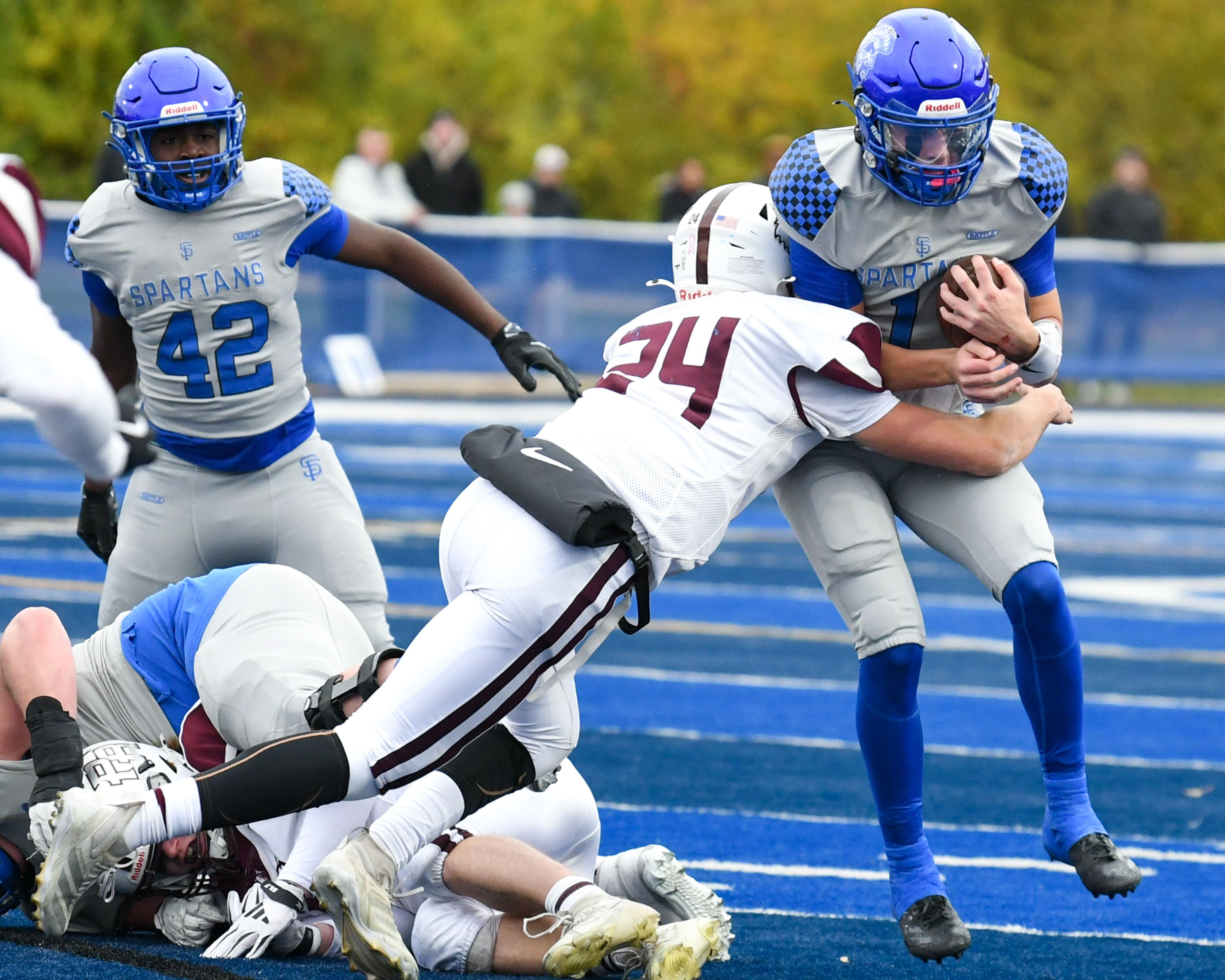 St. Francis's Brock Phillip, right, gains some yards before being brought down by Prairie Ridge's Vincent Byk (24) during the second round of the 5A playoff game on Saturday Nov. 8, 2025, held at St. Francis's High School.
