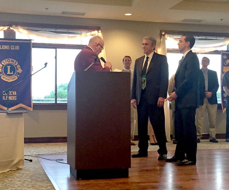 Lions Club District Governor Chris Halsey (left) announces the passing of the gavel from Nick Ninedorf (right) to Jay Moffat (center). Ninedorf will now serve as immediate past president of the Geneva Lions Club as he turns his presidential duties to Moffat.