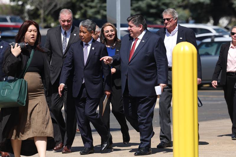 Governor J.B. Pritzker, right center, arrives with Gil Quiniones, CEO of ComEd, left center, outside the G&W Electric building in Bolingbrook. G&W Electric was given a rebate of $2.6 million, the largest rebate to date in Illinois, as part of Com Ed’s Distributed Generation Rebate Program.
