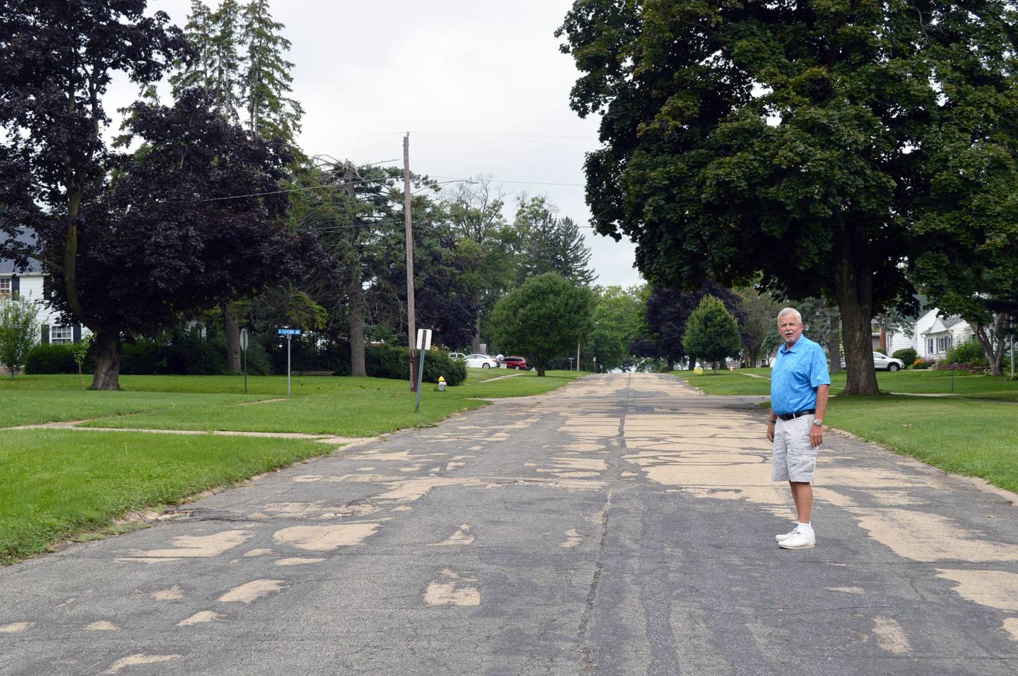 Mt. Morris Village Board Trustee Ed Higley, who is in charge of the streets, stands in the middle of Sunset Lane on Friday, Aug. 2, 2024. The Sunset Lane Project involves reconstructing the entire 5.5-block street, but is on pause this year while village officials review project financing options. Two blocks have been redone so far.