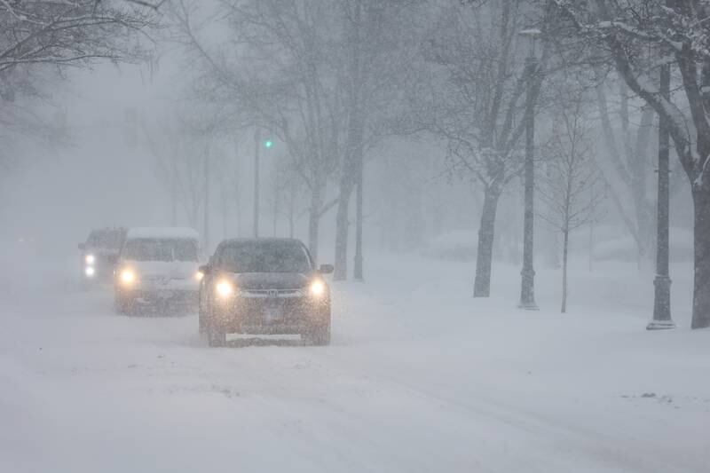 Cars navigate the snow along North Raynor Avenue Wednesday morning. Wednesday, Feb. 2, 2022 in Joliet.