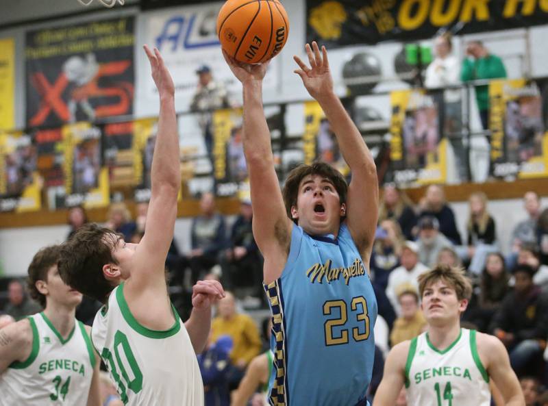 Marquette's Jaxon Rix lets go of a shot over Seneca's Brady Sheedy during the Tri-County Conference championship on Friday, Jan. 31, 2025 at Putnam County High School.