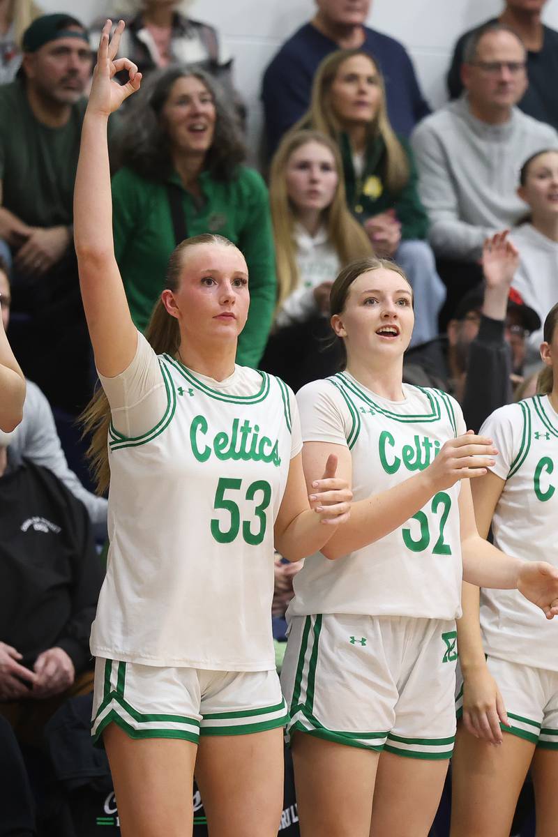 Providence Callahan sisters, Landrie, left, and Layken, cheer on their teammates from the bench in the final minutes in their 72-44 win over Hillcrest in the Class 3A Hillcrest Sectional championship game on Thursday, Feb. 26, 2026 in Hillcrest.