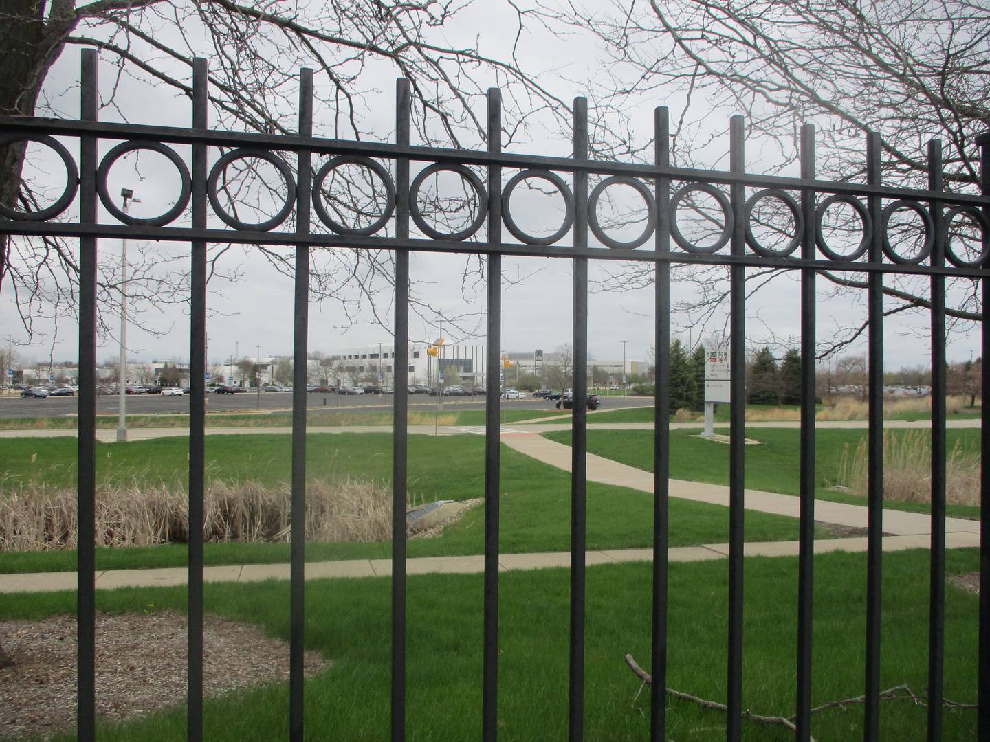 The Joliet Junior College campus can be seen beyond the perimeter fence at Rock Run Residences, an apartment complex originally built to provide housing for students at the college. April 13, 2026