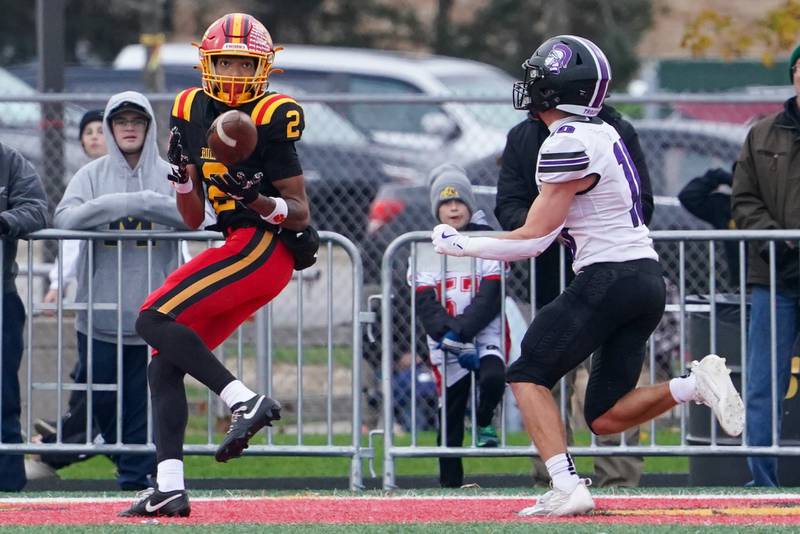 Batavia's Isaiah Brown (2) catches a pass for a touchdown against Downers Grove North's Oliver Thulin (10) during a class 7A quarterfinal playoff football game at Batavia High School on Saturday, Nov. 16, 2024.