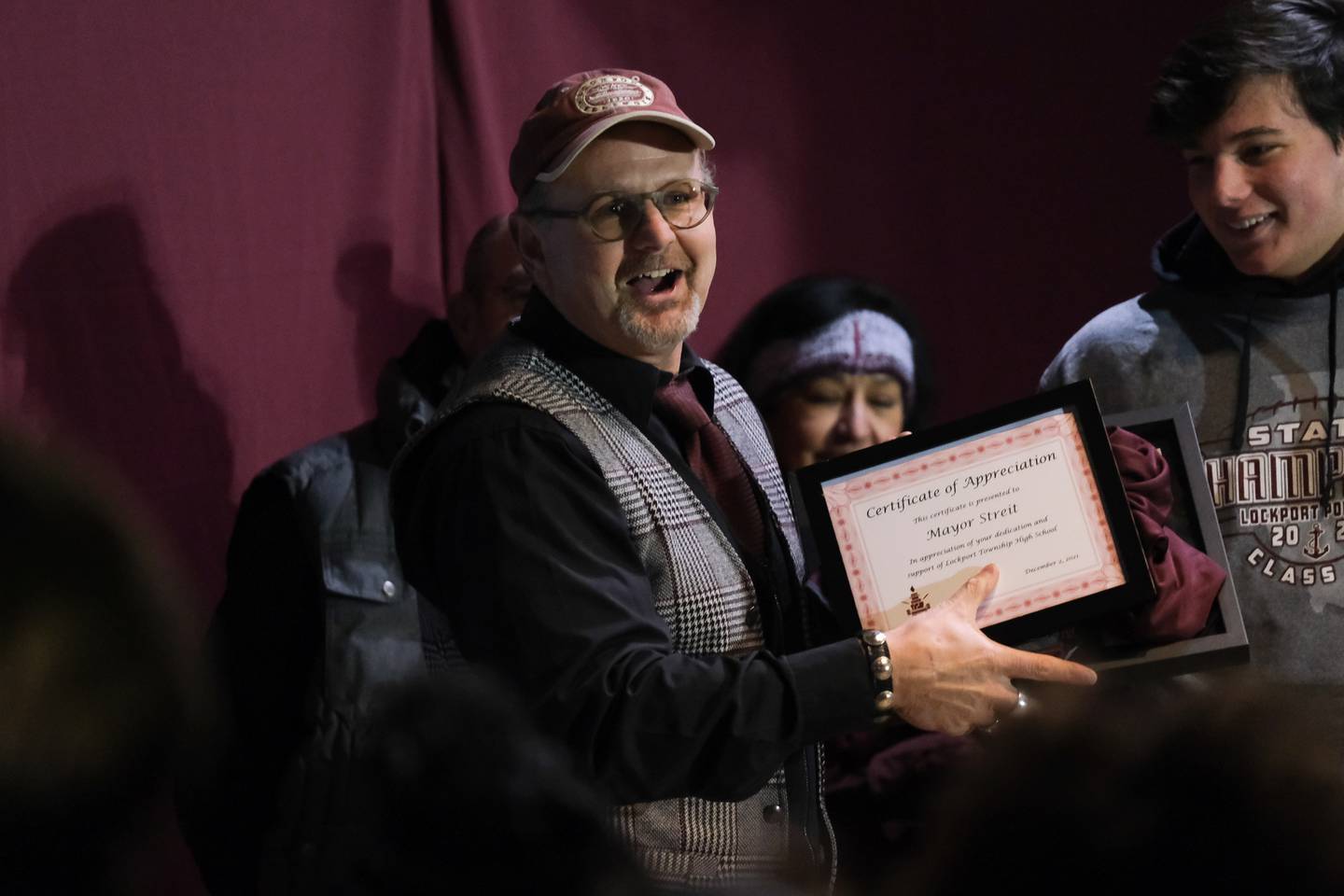 Lockport Mayor Steve Streit is giving a plaque by the football team at the city celebration of Lockport football's state championship at Central Square in downtown Lockport. Thursday, Dec. 2, 2021 in Lockport.