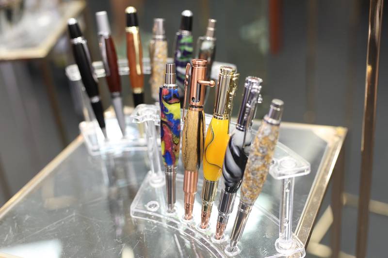 Samson Garcia, a disabled Army veteran, owner of Samson Wood Services, sells his collection of custom pens K9s For Veterans Outlet Store in Bolingbrook, Thursday, July 25, 2024.