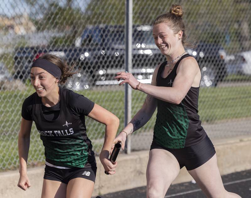 Rock Falls’ Maya Kobbeman takes the baton from Ryleigh Eriks Thursday, May 8, 2025, during the girls Big Northern Conference track meet.