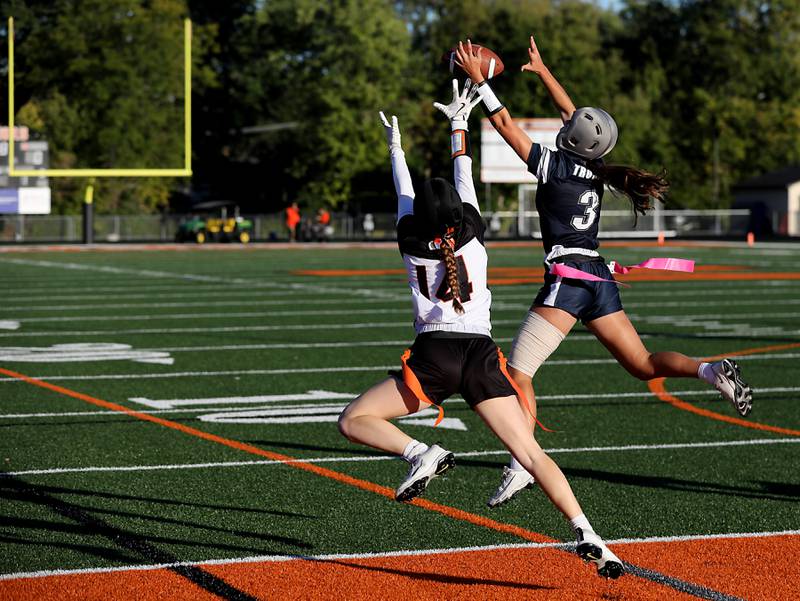 Cary-Grove's Kennedy Manning (right) intercepts a pass intend for McHenry's Morgan Frederick during the IHSA McHenry Regional girls flag football championship game on Wednesday, Oct. 8, 2025, at McCracken Field in McHenry.