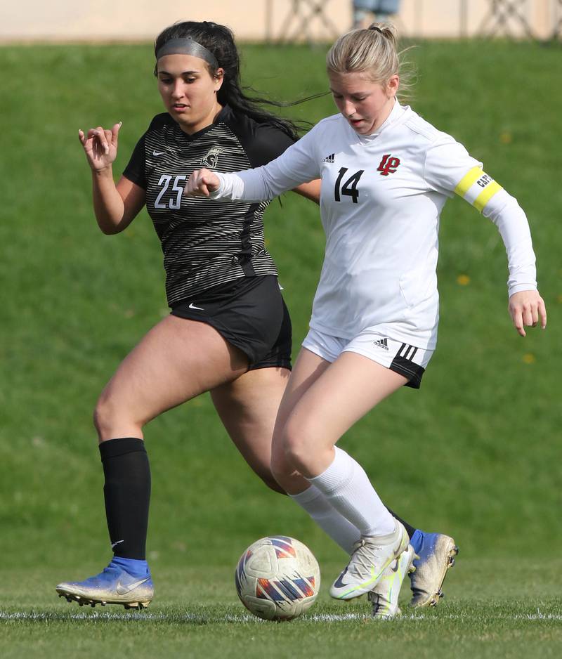 LaSalle-Peru's Nica Hein carries the ball in front of Sycamore's Kaitlyn Goff during their 2023 game , at Sycamore High School.