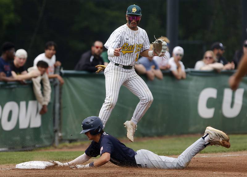 Cary-Grove's Ricky Barnes slides onto third base in front of Crystal Lake South's Yandel Ramirez during the IHSA Class 3A Grayslake Central Sectional Championship baseball game on Saturday, June 7, 2025, at Grayslake Central High School.