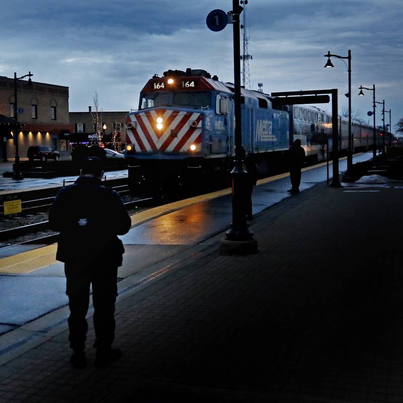 People wait for the Metra train to arrive from Chicago on Tuesday, Feb. 14, 2023, at the Crystal Lake Metra station in downtown Crystal Lake.