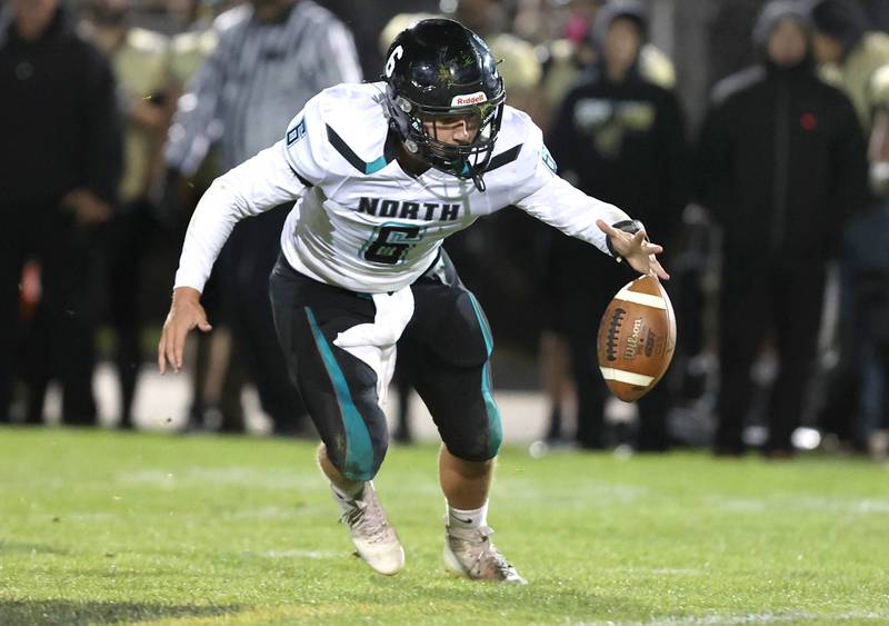 Woodstock North's Jay Zinnen tries to corral a bad snap during their game Friday Oct. 7, 2022, at Sycamore High School.