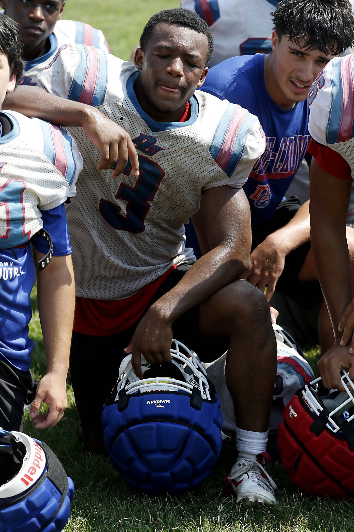 Dundee-Crown's Kadin Malone listens to Head Coach Michael Steinhaus talk as the end of football practice on Tuesday, July 29, 2025, at Dundee-Crown High School in Carpentersville.