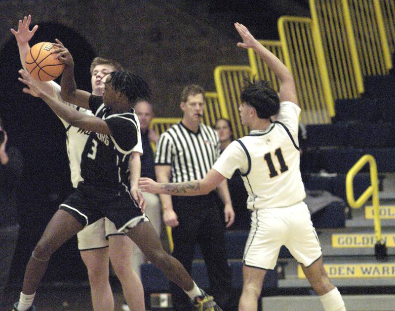 Sterling's Will Ports and Galeburg's Keigan Cummer battle for the ball as Sterling's Nico Battaglia backs up the play. Sterling Boys Basketball hosted Galesburg at Musgrove Fieldhouse on February 11, 2025.