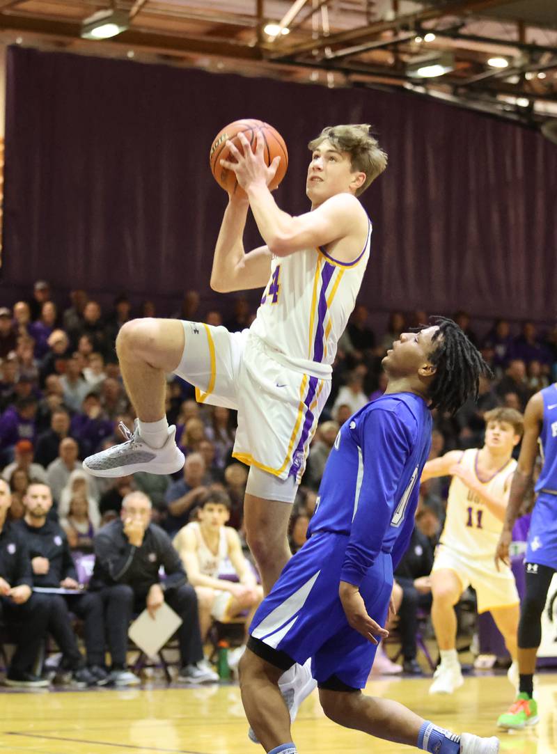 Downers Grove North's Maxwell Haack (14) drives to the basket during the boys 4A varsity regional final between Downers Grove North and Proviso East in Downers Grove on Friday, Feb. 24, 2023.