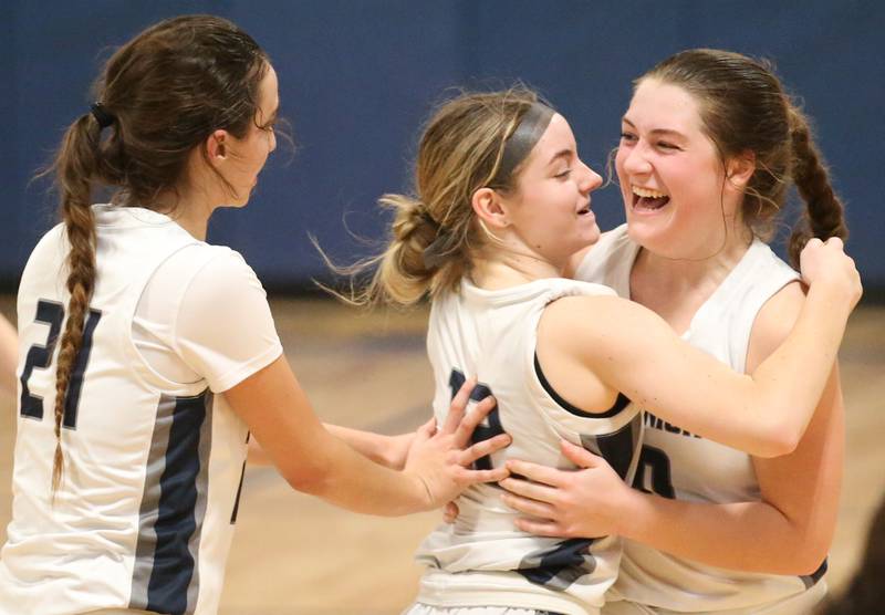 Fieldcrest's Haley Carver (center) is congratulated by her teammates Ashlyn May and Carolyn Megrow after sending the Lady Knights into overtime against Eureka on Monday, Jan. 9, 2023 at Fieldcrest High School.