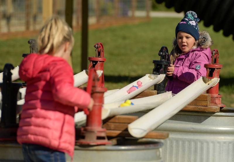 Emma Anderson, 5 of Sycamore plays with the water pump a the Jonamac Orchard in Malta on Wednesday, Sept. 28, 2022.